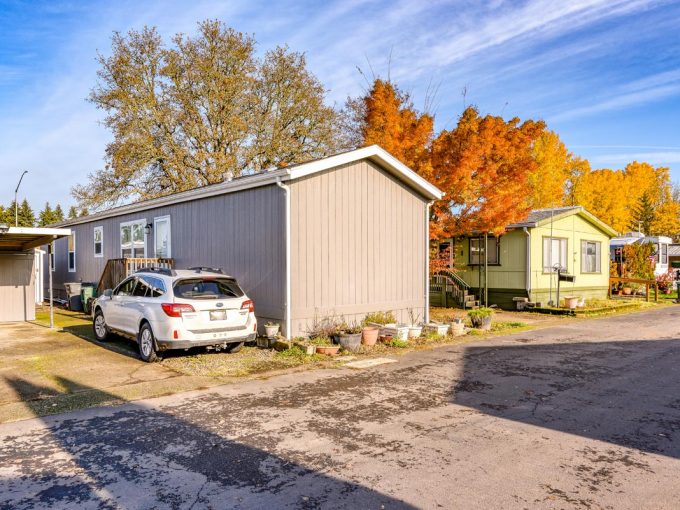 homes in front of trees with vibrant autumn leaves